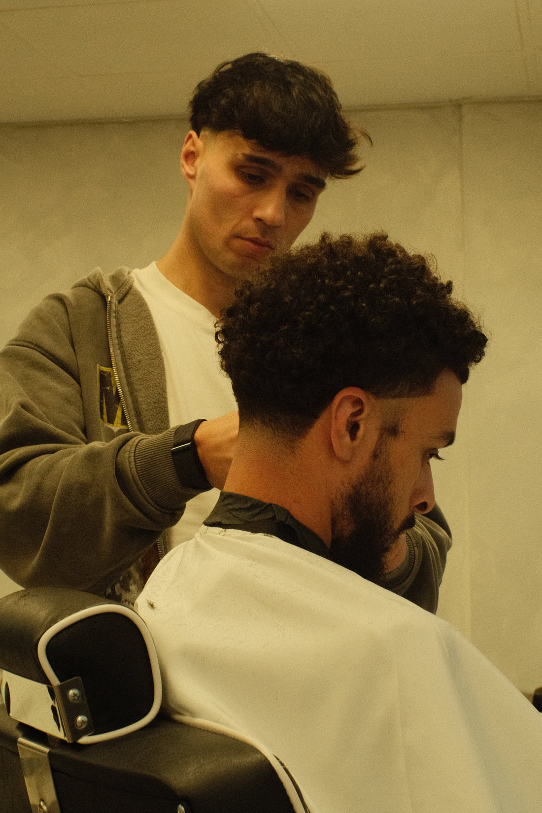 Two men in a Barbershop setting, client getting his Haircut